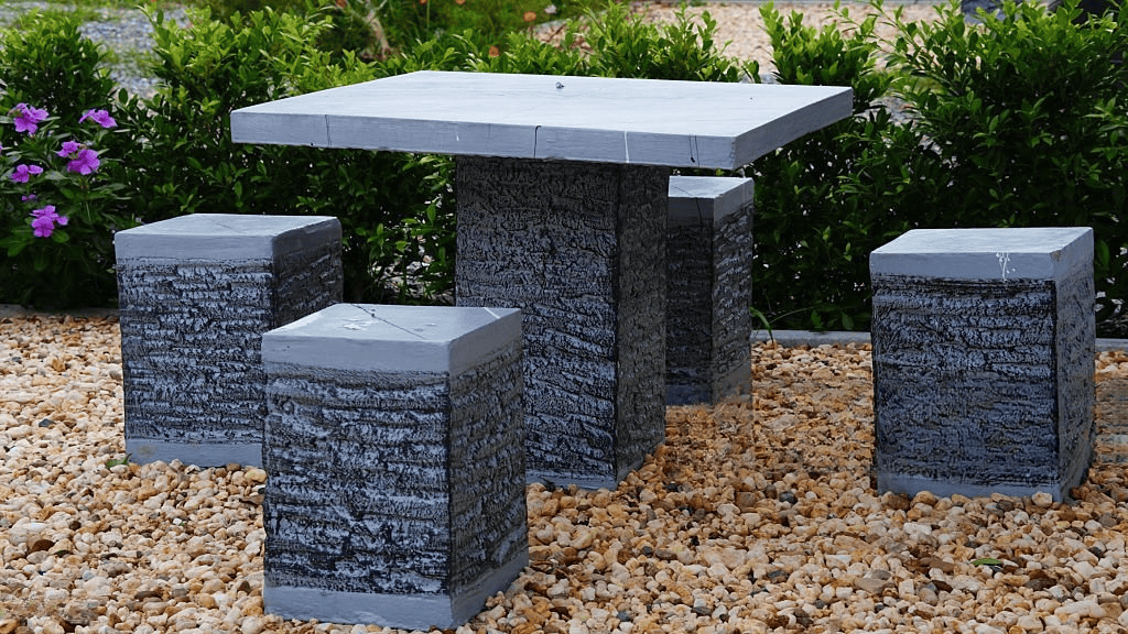 Natural granite table with solid stone stools designed for outdoor garden seating