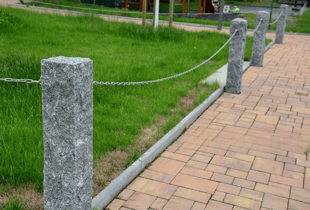 Durable granite bollards with chain links used for walkway edging and landscape control