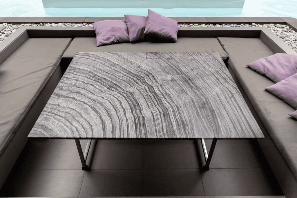 Granite outdoor table top with natural stone pattern for luxury patio and poolside seating
